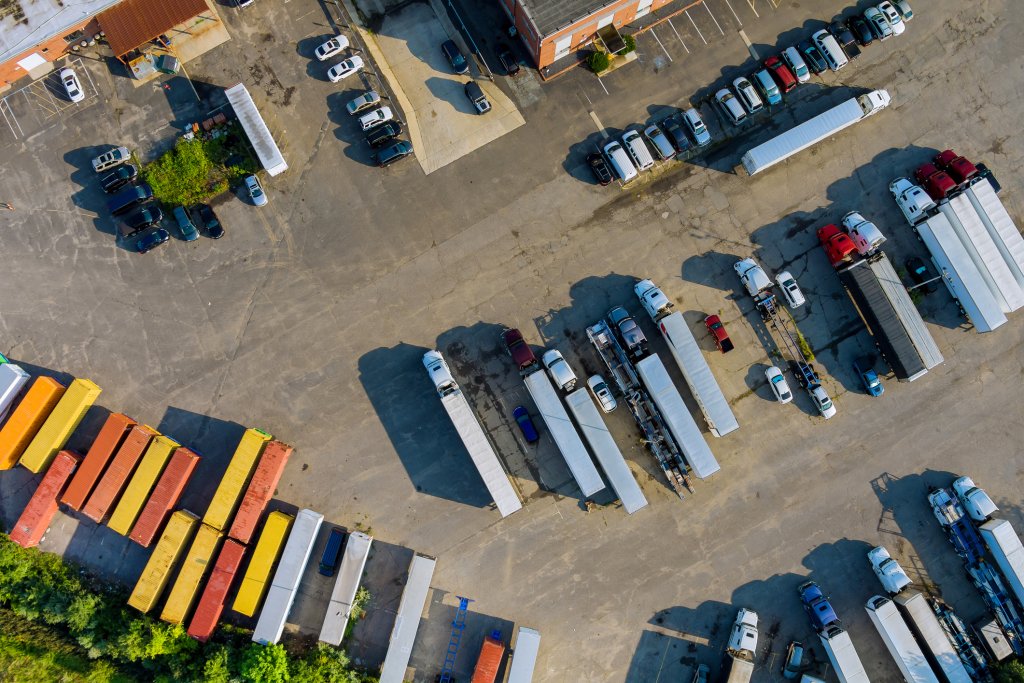 Top view car parking truck stop on rest area in the highway trucks stand in a row