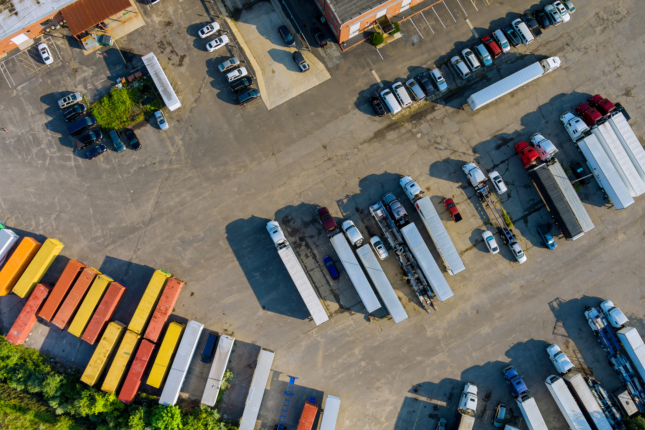 Top view car parking truck stop on rest area in the highway trucks stand in a row